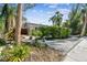 Charming home surrounded by lush landscaping, plants, and a white gravel yard at 913 Tennessee Ln, Sarasota, FL 34234