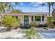 A charming home with a well-kept lawn and garden beds leading to the front entrance at 913 Tennessee Ln, Sarasota, FL 34234