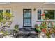Close up of the front entrance featuring a black framed glass door and small garden beds at 913 Tennessee Ln, Sarasota, FL 34234