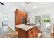 Modern kitchen with stainless steel appliances and a large island with a granite countertop at 913 Tennessee Ln, Sarasota, FL 34234
