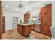 Well-equipped kitchen with stainless steel appliances, wooden cabinets, and an island with granite countertops at 913 Tennessee Ln, Sarasota, FL 34234