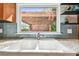 Kitchen sink with a window overlooking an outdoor pergola at 913 Tennessee Ln, Sarasota, FL 34234