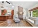Open-concept living room featuring hardwood floors, brick fireplace, and natural light at 913 Tennessee Ln, Sarasota, FL 34234