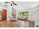 Open-concept living room featuring hardwood floors, brick fireplace, and natural light at 913 Tennessee Ln, Sarasota, FL 34234