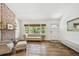 Bright living room featuring a brick fireplace, a sofa, and wood-look floors at 913 Tennessee Ln, Sarasota, FL 34234
