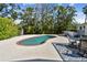 Backyard pool surrounded by tropical landscaping, dining area and shed in backyard at 913 Tennessee Ln, Sarasota, FL 34234