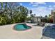 Kidney bean pool with outdoor dining area and tropical landscaping in the backyard at 913 Tennessee Ln, Sarasota, FL 34234