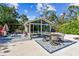 Beautiful pool area with an enclosed lanai, outdoor dining, and a lush tropical garden at 913 Tennessee Ln, Sarasota, FL 34234
