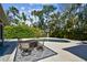 Backyard pool with an outdoor seating area and surrounded by lush tropical landscaping at 913 Tennessee Ln, Sarasota, FL 34234