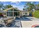 Back of house featuring pool, sunroom, and outdoor dining area with patterned rug at 913 Tennessee Ln, Sarasota, FL 34234