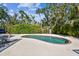 Refreshing pool with outdoor dining and mature landscaping in backyard at 913 Tennessee Ln, Sarasota, FL 34234