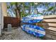 Functional side yard features a pair of surfboards mounted on the fence at 913 Tennessee Ln, Sarasota, FL 34234