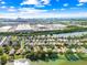 Expansive aerial view of a residential area near a lake, highlighting community layout and proximity to industrial area at 12511 Lake Vista Dr, Gibsonton, FL 33534