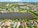 Panoramic aerial view of a residential area with a lake, showcasing the community's layout and environment at 12511 Lake Vista Dr, Gibsonton, FL 33534