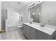 Bathroom with dual sink vanity, bathtub and separate shower with glass door at 12511 Lake Vista Dr, Gibsonton, FL 33534