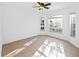 Bright bedroom features tile flooring, three windows, and a ceiling fan at 12511 Lake Vista Dr, Gibsonton, FL 33534