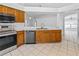 Kitchen with wood cabinets, stainless steel appliances, and tile flooring at 12511 Lake Vista Dr, Gibsonton, FL 33534
