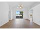 Spacious and bright living room featuring tile floors, a ceiling fan, and large sliding glass doors with lake view at 12511 Lake Vista Dr, Gibsonton, FL 33534