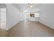 Open-concept living room with neutral tile floors and view to the front entrance and kitchen at 12511 Lake Vista Dr, Gibsonton, FL 33534