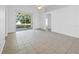 Bright living room features neutral tile floors and sliding glass doors to the backyard at 12511 Lake Vista Dr, Gibsonton, FL 33534