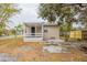 Backyard view of home with screened patio and exterior stone at 2001 16Th S St, St Petersburg, FL 33705