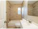 This bright bathroom features tiled walls, shower, and vanity at 2001 16Th S St, St Petersburg, FL 33705
