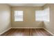 Bright bedroom with wood flooring and ample natural light from two windows at 2001 16Th S St, St Petersburg, FL 33705