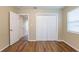This bedroom features wood floors, closet, and entry doorway at 2001 16Th S St, St Petersburg, FL 33705