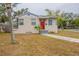 Charming single-story home with a bright red front door and well-maintained lawn at 2001 16Th S St, St Petersburg, FL 33705