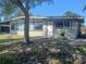 Single story home with large windows and a white front door at 316 Country Club Dr, Oldsmar, FL 34677