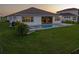 Gorgeous backyard with a pool, jacuzzi, and well maintained lawn at 8936 Sanders Tree Loop, Wesley Chapel, FL 33545