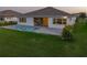 Picture-perfect backyard featuring a sparkling pool and lush green lawn perfect for relaxing and entertaining at 8936 Sanders Tree Loop, Wesley Chapel, FL 33545