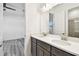 Double sink vanity featuring dark wood cabinets and bright countertops at 8936 Sanders Tree Loop, Wesley Chapel, FL 33545
