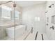 Elegant bathroom showcasing a freestanding tub, a spacious glass-enclosed shower, and modern fixtures at 8936 Sanders Tree Loop, Wesley Chapel, FL 33545