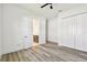 Bright bedroom featuring wood floors, a closet, and an ensuite bathroom at 8936 Sanders Tree Loop, Wesley Chapel, FL 33545