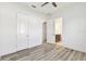 Bedroom featuring wood floors and ensuite bathroom at 8936 Sanders Tree Loop, Wesley Chapel, FL 33545