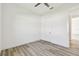 Bedroom featuring wood floors, a ceiling fan, and ensuite bathroom at 8936 Sanders Tree Loop, Wesley Chapel, FL 33545