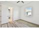Bedroom featuring wood floors and a window overlooking the neighborhood at 8936 Sanders Tree Loop, Wesley Chapel, FL 33545