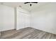 Bedroom with wood floors, a ceiling fan and a large white closet at 8936 Sanders Tree Loop, Wesley Chapel, FL 33545