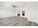 A modern bedroom featuring wood-look floors, a ceiling fan, and access to an elegant bathroom with stylish finishes at 8936 Sanders Tree Loop, Wesley Chapel, FL 33545