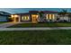 Charming home featuring a modern design, well-manicured lawn, and inviting curb appeal at 8936 Sanders Tree Loop, Wesley Chapel, FL 33545