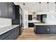 Elegant kitchen with gray cabinets, stainless appliances, a pantry, and a center island at 8936 Sanders Tree Loop, Wesley Chapel, FL 33545