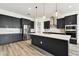 Spacious kitchen with a center island, stainless steel appliances, and modern pendant lighting at 8936 Sanders Tree Loop, Wesley Chapel, FL 33545
