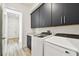 Modern laundry area with cabinetry, counter space, washer, and dryer at 8936 Sanders Tree Loop, Wesley Chapel, FL 33545