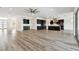 Expansive open-plan living space featuring a kitchen with a large island, and wood-look flooring throughout at 8936 Sanders Tree Loop, Wesley Chapel, FL 33545