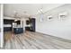 Bright, open living room with modern finishes, and view of the modern kitchen at 8936 Sanders Tree Loop, Wesley Chapel, FL 33545