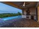Outdoor kitchen and pool featuring a grill and lush view, perfect for entertaining outdoors at 8936 Sanders Tree Loop, Wesley Chapel, FL 33545