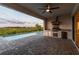 Beautifully paved patio with a built-in outdoor kitchen, bbq, and pool overlooking the yard at 8936 Sanders Tree Loop, Wesley Chapel, FL 33545