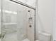 Walk-in shower featuring marble tile, glass door, and bronze fixtures at 8936 Sanders Tree Loop, Wesley Chapel, FL 33545