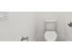 Compact toilet in a minimalist, all-white designed powder room at 8936 Sanders Tree Loop, Wesley Chapel, FL 33545